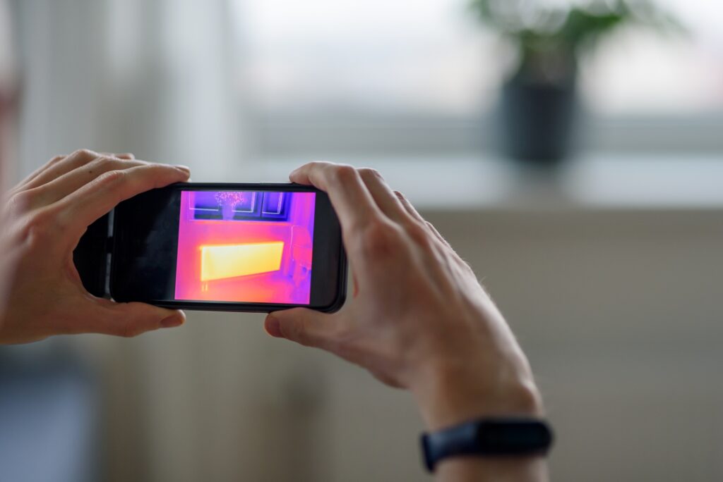 Person doing thermal scanning of apartment